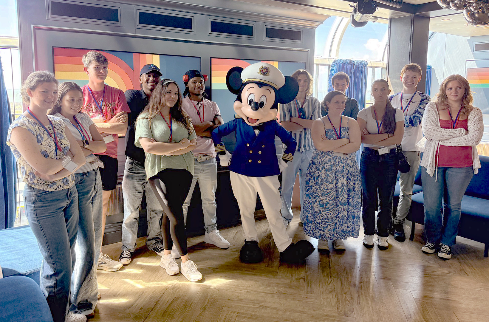 As part of Port Canaveral's Junior Ambassador program, twelve student pose together for a photo with Mickey Mouse aboard a Disney Cruise Line ship..