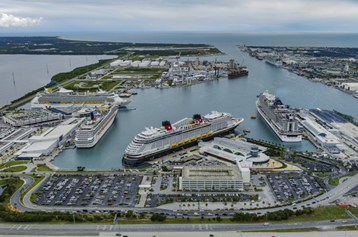 Wide aerial view of a 9-ship day at Port Canaveral looking east