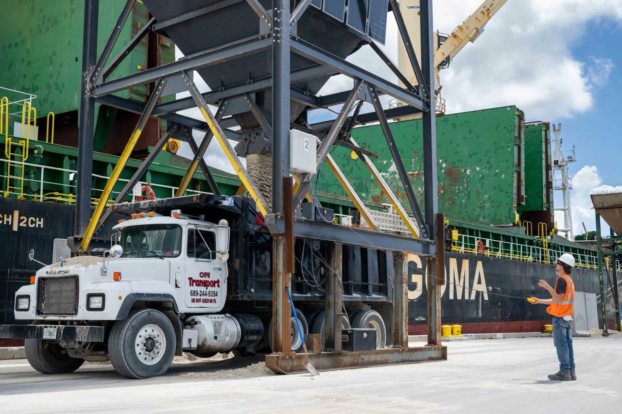 SAND_SIDER-MOMPOX-Sand-Import-SCB2-063026-SELECT-15-Large Sand is discharged via a hopper into a truck at Port Canaveral.