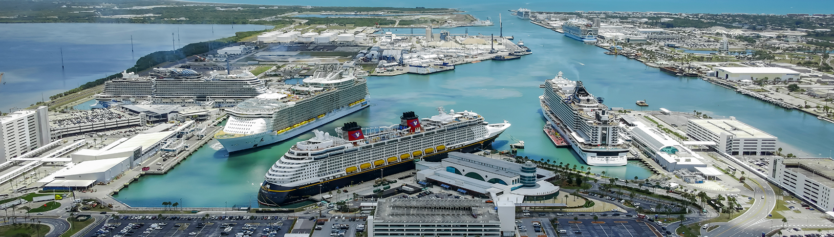Port Canaveral aerial image showing 6 cruise ships at their terminals.