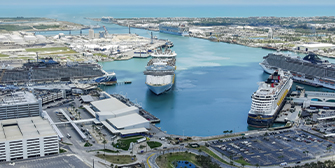 Aerial image showing six cruise ships docked at Port Canaveral cruise terminal.