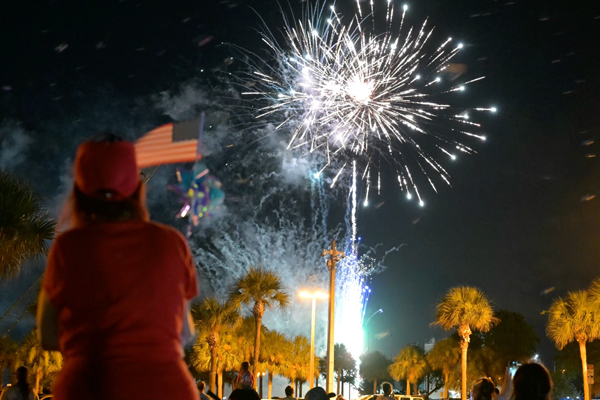 AwomanwavesanAmericanflagataPortCanaveralspecialIndependenceDayevent