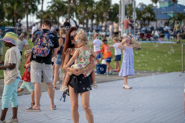MomanddaughterplayinbubblesatPortCanaveral