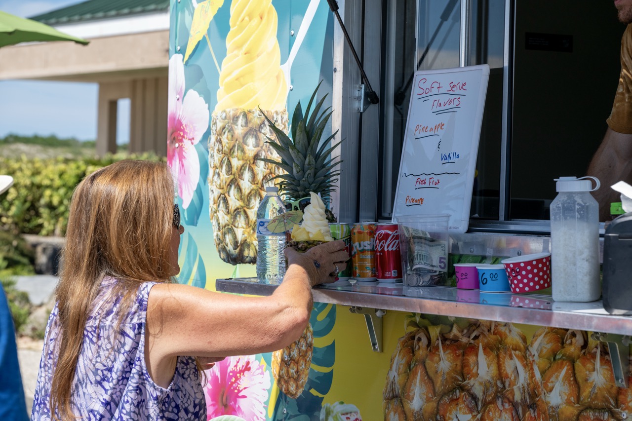 DolewhipservedinapineappleispurchasedfromafoodtruckvendoratJettyPark